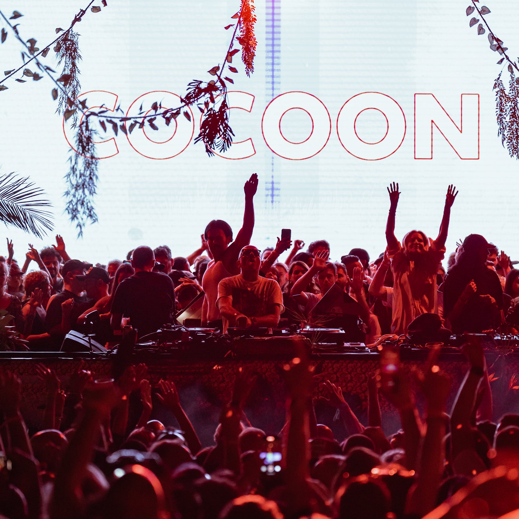 Sven Väth performing at the Official Cocoon Events party at 528 Ibiza with a massive crowd in the background.