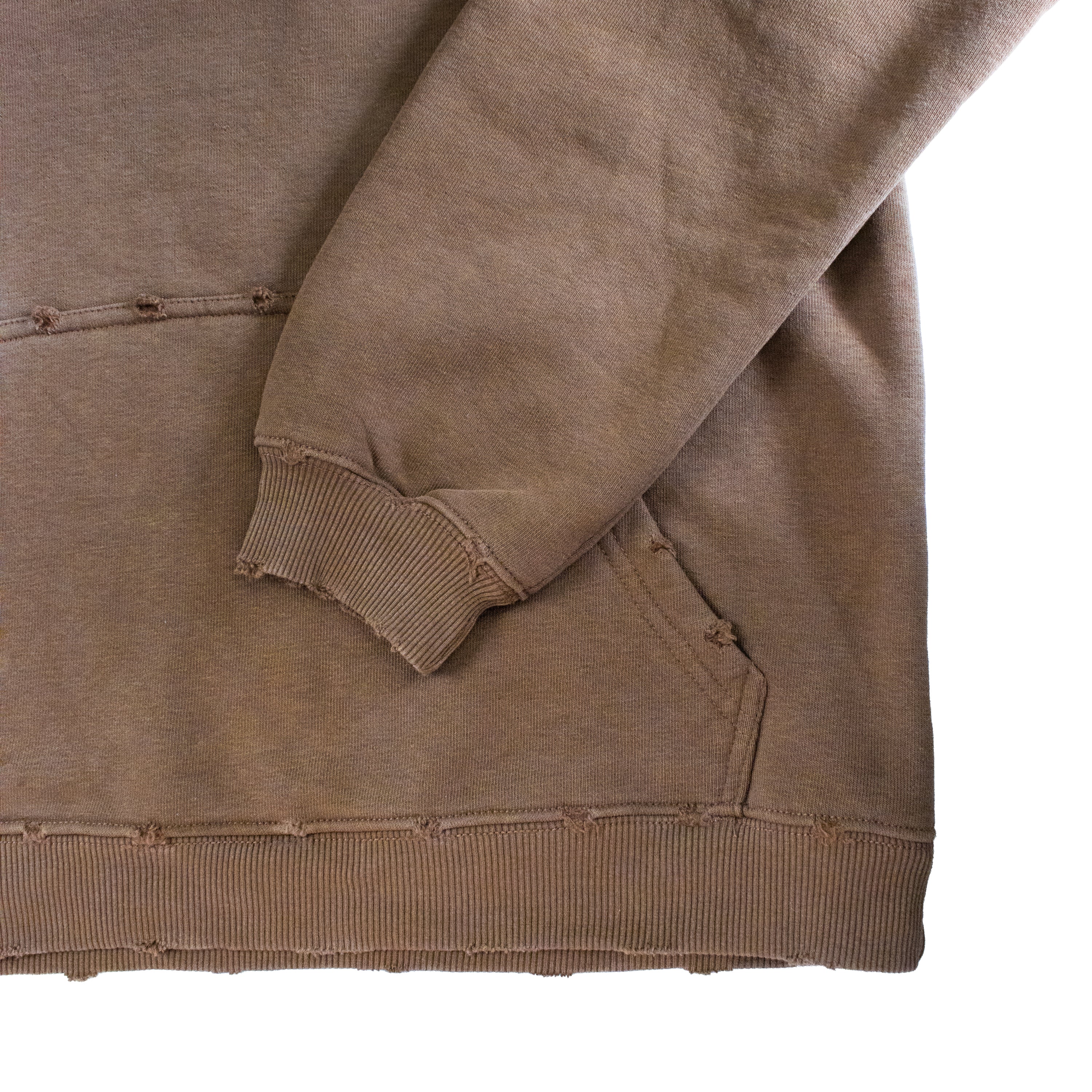 Brown sweatshirt with a focus on the sleeve and hem on a white background