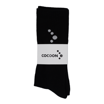 Black socks with a white label featuring the 'Cocoon' brand on a white background