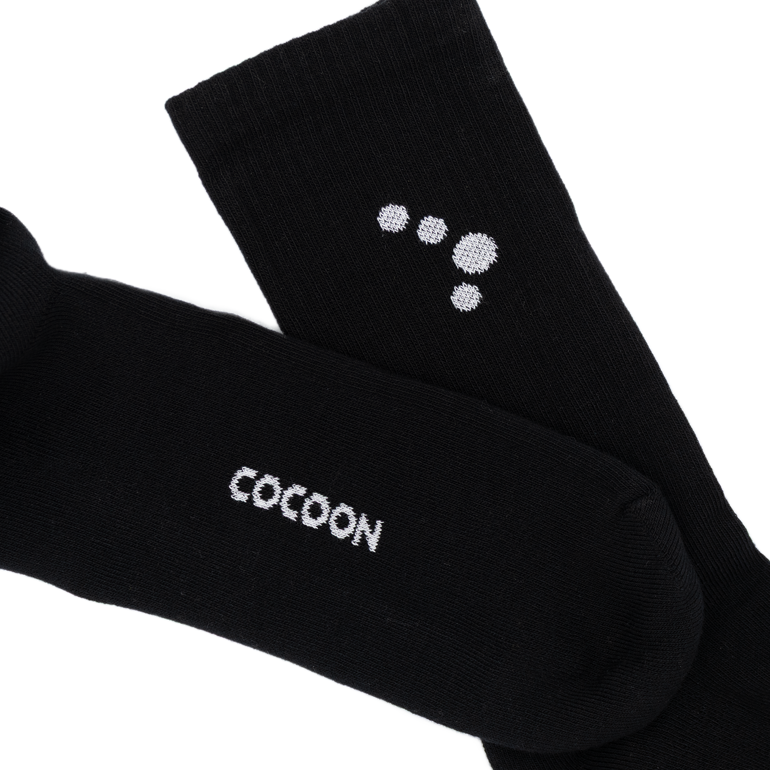 Black socks with 'Cocoon' branding on a white background