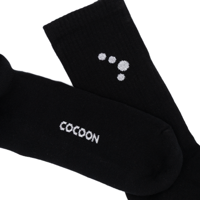 Black socks with 'Cocoon' branding on a white background
