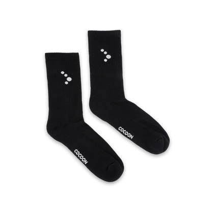 Black socks with white symbols and 'Cocoon' branding on a white background